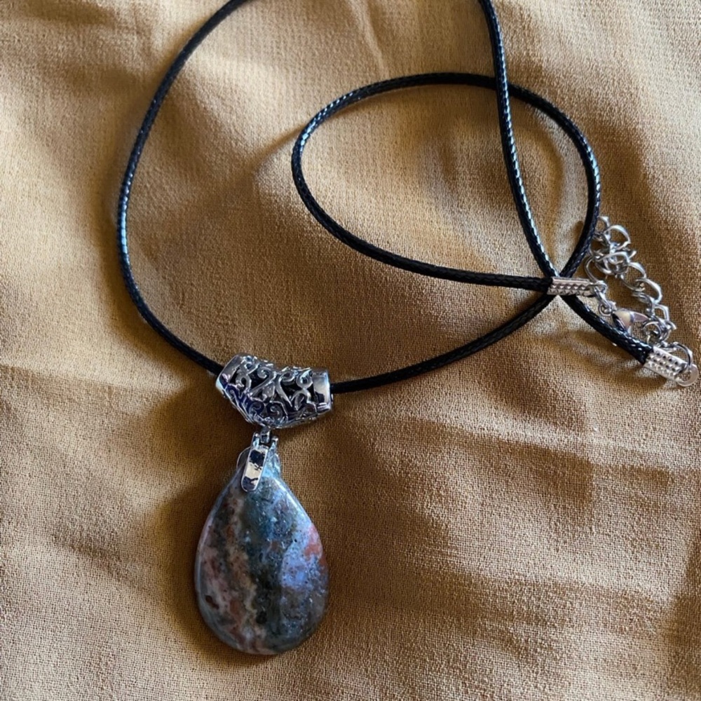 agate stone and silver plated tear pendant, on a black cord necklace.